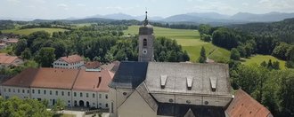 Kirchturm mit Alpen im Hintergrund